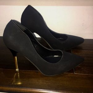 Closed toe Black pumps with gold accent on heel